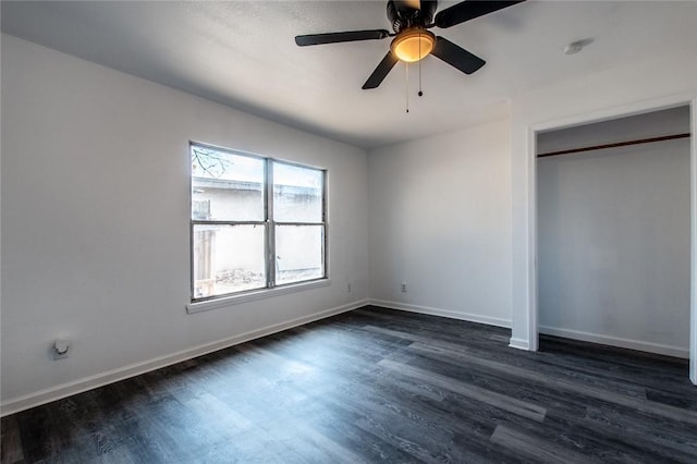 unfurnished bedroom with dark hardwood / wood-style floors, ceiling fan, and a closet