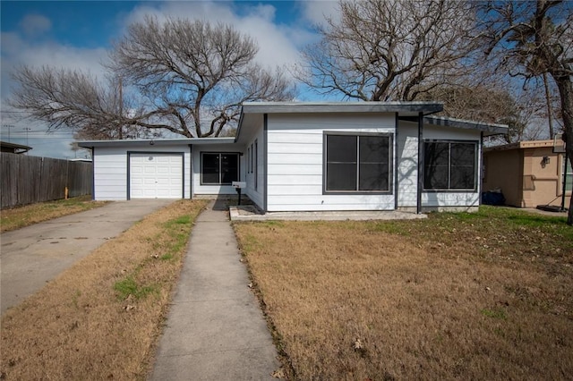 view of front of property featuring a garage and a front lawn