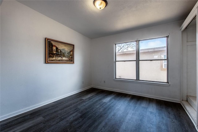 spare room with dark hardwood / wood-style floors