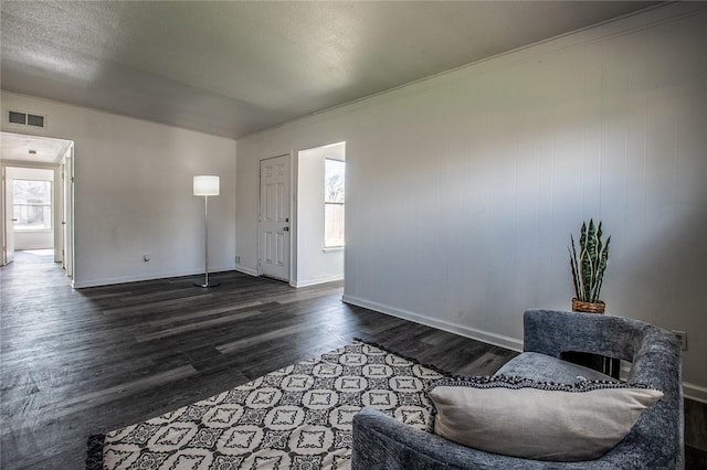 foyer entrance with dark hardwood / wood-style flooring and a healthy amount of sunlight