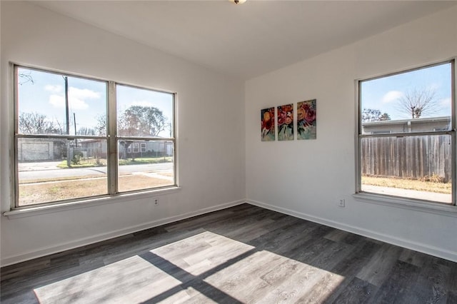 spare room with dark hardwood / wood-style floors