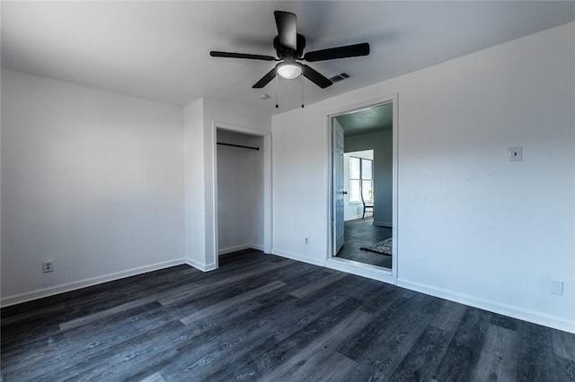 unfurnished bedroom with ceiling fan, dark hardwood / wood-style flooring, and a closet