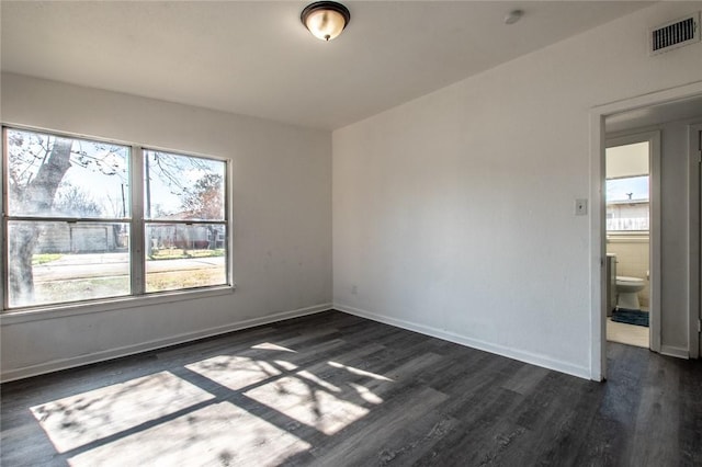 spare room with dark hardwood / wood-style flooring