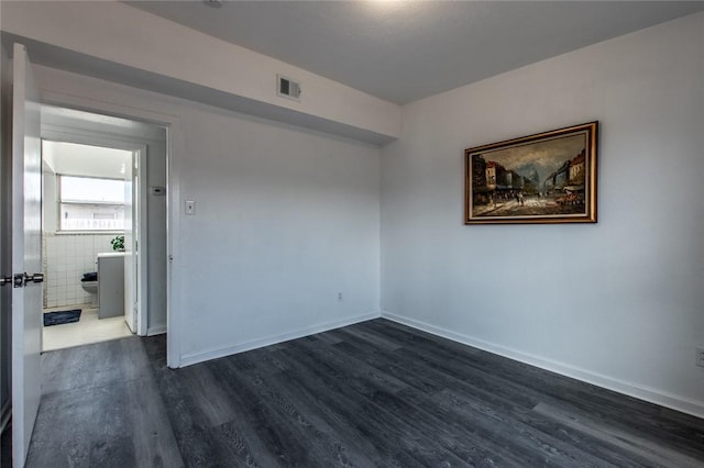 unfurnished room featuring dark hardwood / wood-style flooring