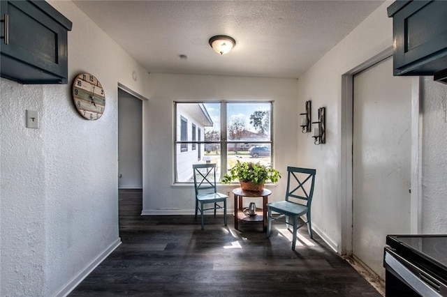 hallway featuring dark hardwood / wood-style floors and a textured ceiling