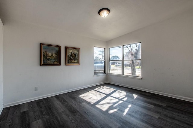 empty room with dark hardwood / wood-style flooring