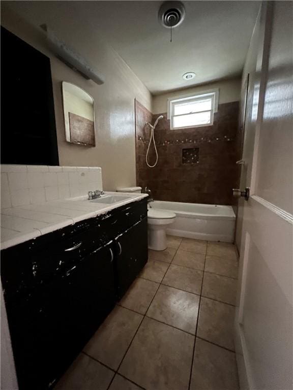 full bathroom featuring toilet, tile patterned flooring, washtub / shower combination, and vanity