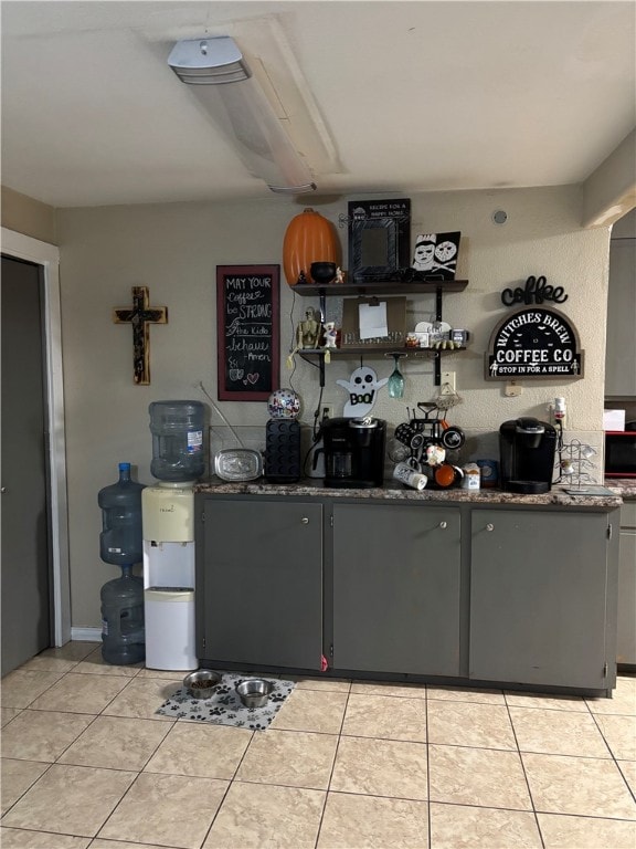 bar featuring gray cabinets and light tile patterned flooring