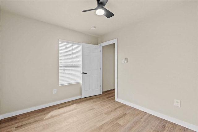 unfurnished bedroom with ceiling fan, wood finished floors, and baseboards