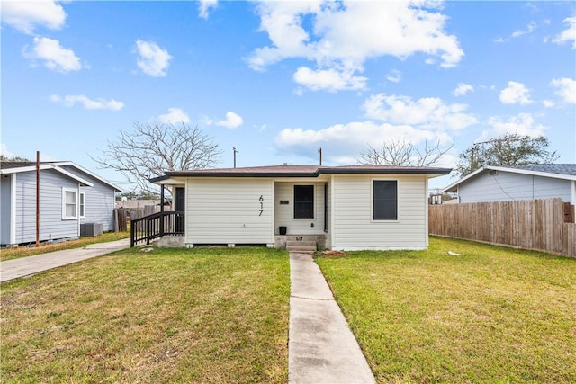 bungalow with entry steps, fence, cooling unit, and a front yard