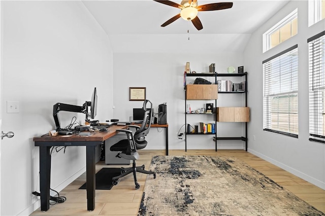 office featuring lofted ceiling, a wealth of natural light, light hardwood / wood-style floors, and ceiling fan