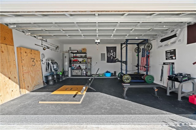 garage with electric water heater and electric panel