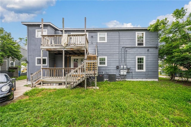 back of house featuring stairs, central AC unit, a lawn, and a wooden deck