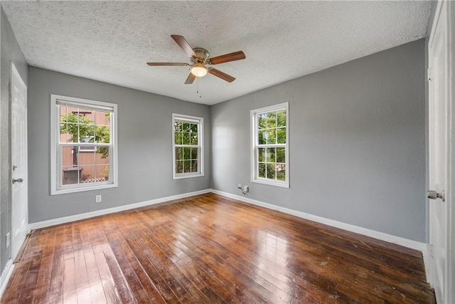 unfurnished room featuring baseboards, a ceiling fan, and hardwood / wood-style flooring