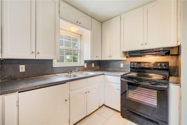 kitchen with under cabinet range hood, electric range, white cabinets, and a sink