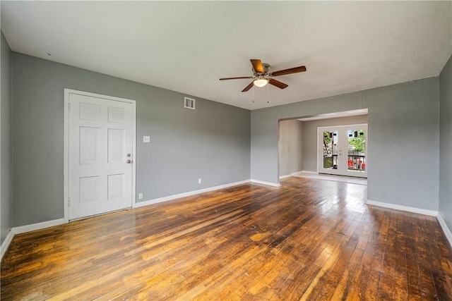 spare room with french doors, hardwood / wood-style floors, a ceiling fan, baseboards, and visible vents