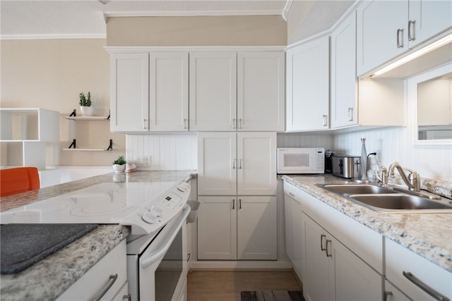 kitchen featuring white cabinetry, sink, light stone counters, white appliances, and ornamental molding