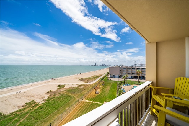 balcony featuring a view of the beach and a water view