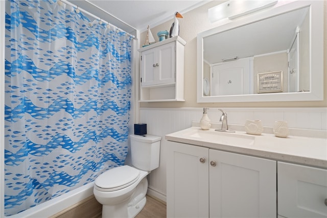 bathroom with a shower with shower curtain, hardwood / wood-style floors, vanity, and toilet