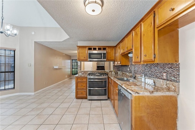 kitchen with light tile patterned floors, brown cabinets, a sink, stainless steel appliances, and tasteful backsplash