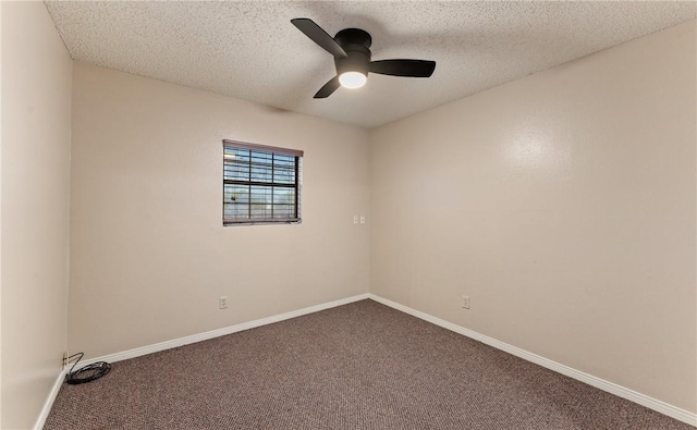 carpeted spare room with a ceiling fan, baseboards, and a textured ceiling