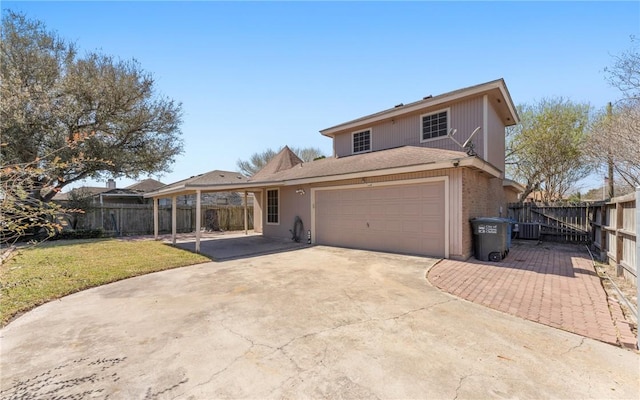 view of front of home with central AC, concrete driveway, a front lawn, and fence