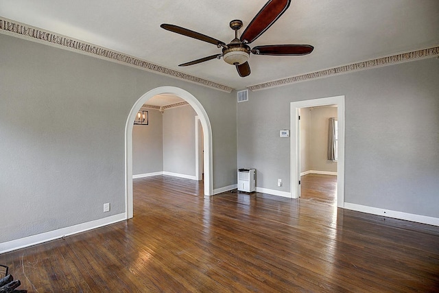 spare room featuring crown molding, ceiling fan, and dark wood-type flooring