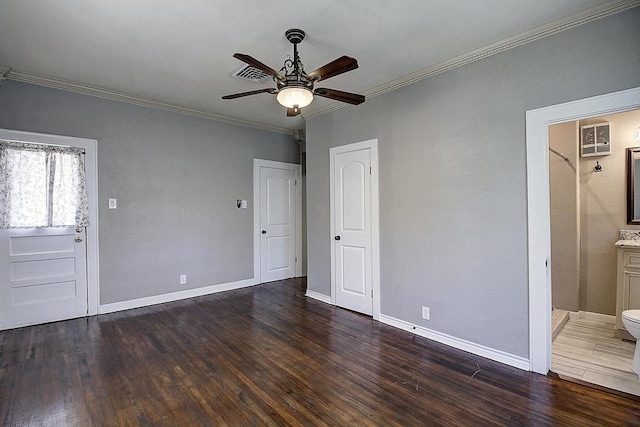 unfurnished bedroom featuring ceiling fan, ornamental molding, dark wood-type flooring, and ensuite bath