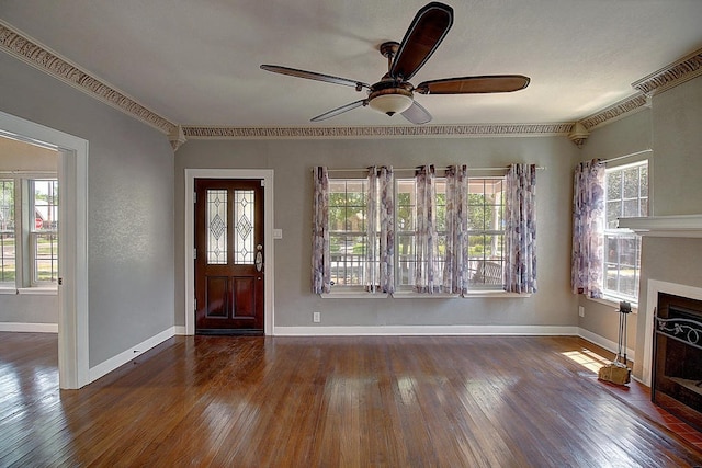 foyer with ceiling fan, dark hardwood / wood-style flooring, and ornamental molding