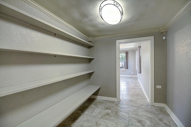 hallway featuring a textured ceiling and ornamental molding