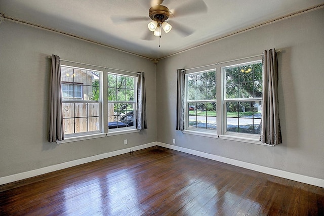 unfurnished room featuring ceiling fan, a healthy amount of sunlight, and dark hardwood / wood-style flooring