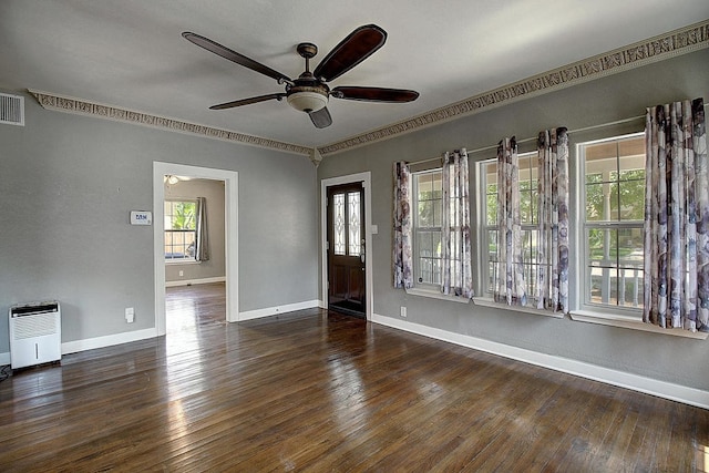 empty room featuring ceiling fan, dark wood-type flooring, and ornamental molding