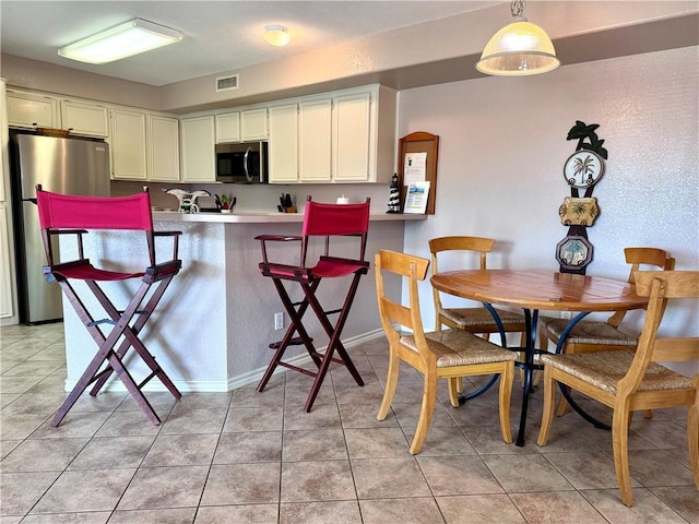 15125 Leeward Dr Unit 10, Corpus Christi, TX 78418 - kitchen with stainless steel appliances, light countertops, a peninsula, and light tile patterned flooring