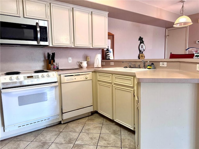 15125 Leeward Dr Unit 10, Corpus Christi, TX 78418 - kitchen featuring white appliances, a peninsula, light tile patterned floors, light countertops, and decorative light fixtures