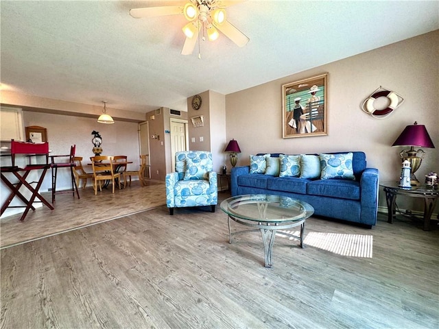 15125 Leeward Dr Unit 10, Corpus Christi, TX 78418 - living room with wood finished floors, a ceiling fan, and a textured ceiling