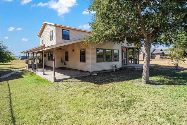 rear view of property with a yard and a patio