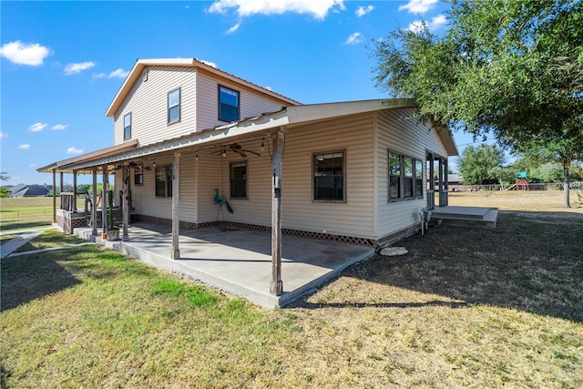 back of property featuring a patio area and a yard