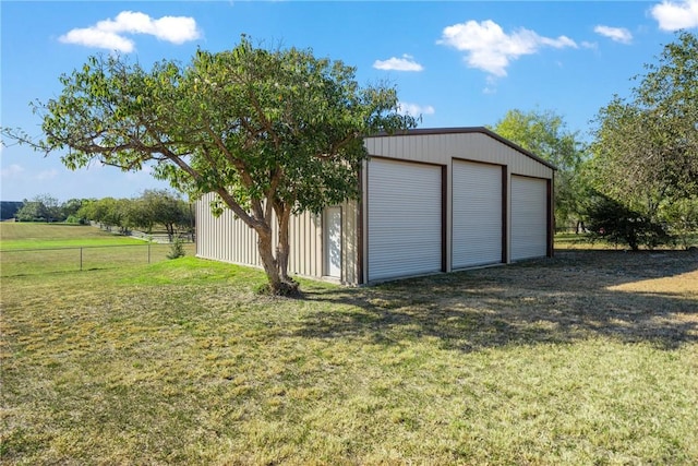 view of outbuilding with a garage and a lawn