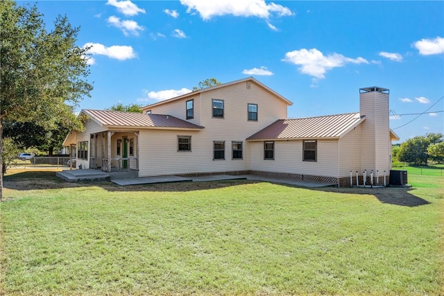 rear view of house with a yard, a patio, and central air condition unit