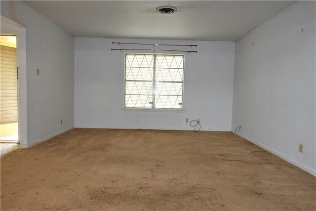 carpeted spare room featuring visible vents and baseboards