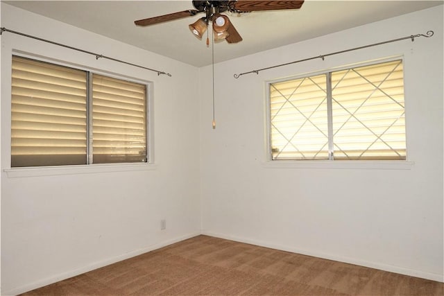 unfurnished room with ceiling fan, carpet floors, and baseboards