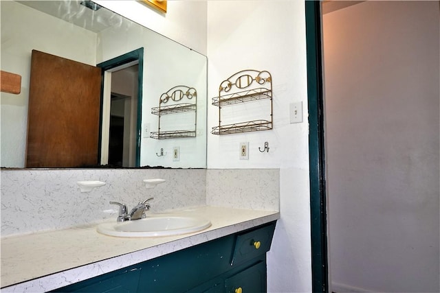 bathroom with tasteful backsplash and vanity