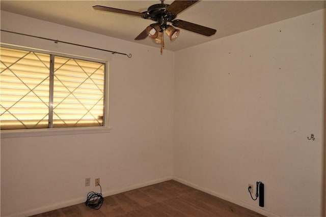 unfurnished room featuring ceiling fan and baseboards