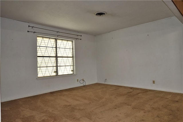 unfurnished room with visible vents and carpet flooring