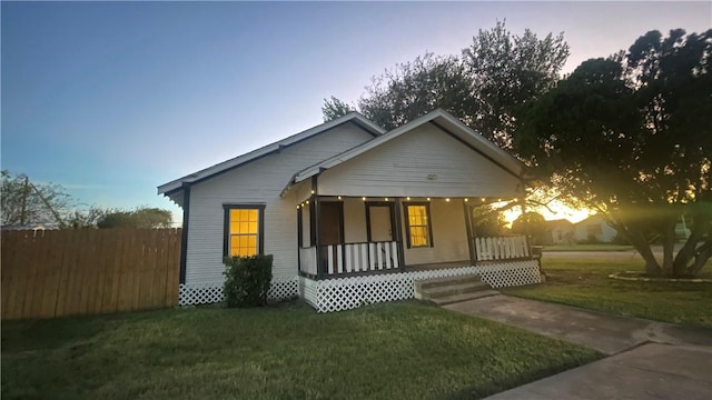 view of front of house with a lawn and covered porch