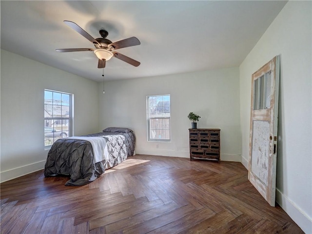 bedroom featuring ceiling fan and dark parquet floors