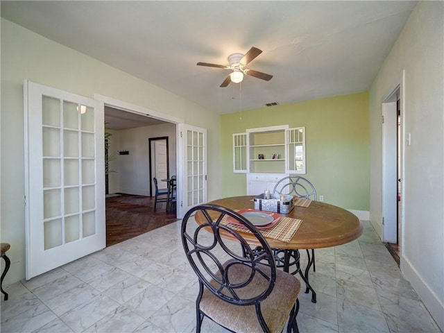 dining area with french doors and ceiling fan