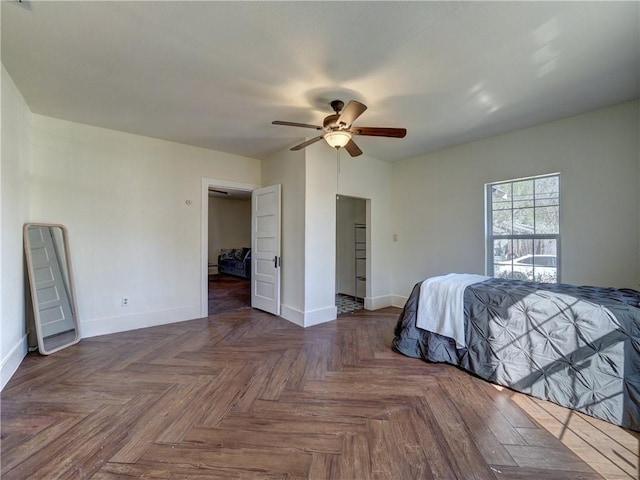 unfurnished bedroom featuring dark parquet flooring and ceiling fan