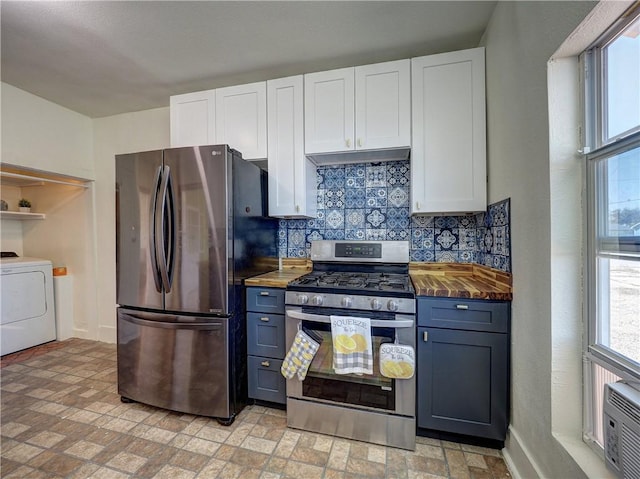 kitchen featuring white cabinets, stainless steel appliances, washer / clothes dryer, and wooden counters