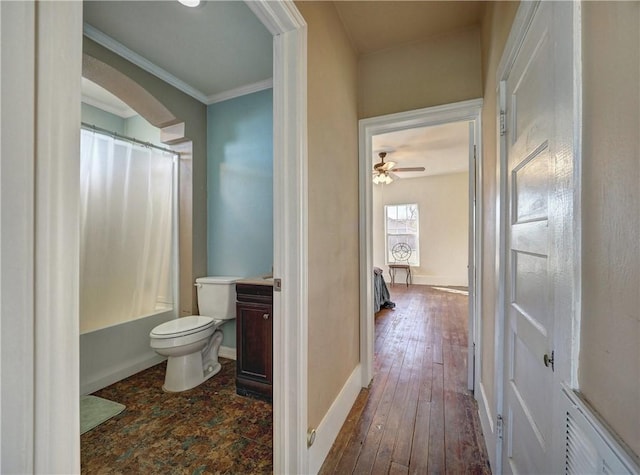 full bathroom with ceiling fan, shower / bathtub combination with curtain, toilet, vanity, and hardwood / wood-style flooring